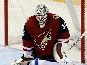 Arizona Coyotes goalie Louis Domingue (35) makes a save against Winnipeg Jets right wing Blake Wheeler in the second period during an NHL hockey game, Thursday, Dec. 31, 2015, in Glendale, Ariz. (AP Photo/Rick Scuteri)