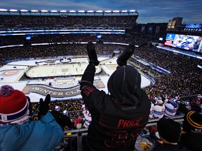 Tarek Sawan, right, and Alexandra Desbiens celebrate a goal by Montreal Canadiens left wing Max Pacioretty during the third period of the NHL Winter Classic hockey game against the Boston Bruins at Gillette Stadium in Foxborough, Mass., Friday, Jan. 1, 2016. The Canadiens won 5-1. (AP Photo/Charles Krupa)