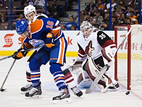 Edmonton's Teddy Purcell (16) tries to tip a shot past Arizona's goalie Louis Domingue (35) during the second period of the Edmonton Oilers' NHL hockey game against the Arizona Coyotes at Rexall Place in Edmonton, Alta., on Saturday, Jan. 2, 2016. Codie McLachlan/Edmonton Sun/Postmedia Network