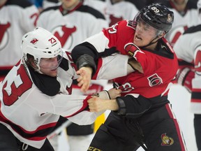 Dec 30, 2015; Ottawa, Ontario, CAN; New Jersey Devils right wing Bobby Farnham (23) fights with Ottawa Senators right wing Max McCormick (89) in the first period at the Canadian Tire Centre. Mandatory Credit: Marc DesRosiers-USA TODAY Sports