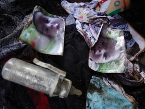 Photos of a one-and-a-half year old boy, Ali Dawabsheh, lie  in a house that had been torched in a suspected attack by Jewish settlers  in Duma village near the West Bank city of Nablus, on July 31, 2015. (AP Photo/Majdi Mohammed)