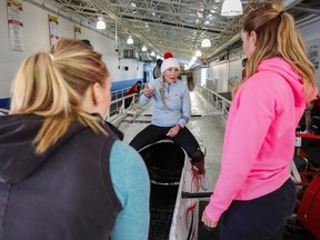 Olympic women's bobsled champion Kaillie Humphries, second from right, gives instruction to her crew while training in Calgary on Saturday, Jan. 2, 2016. Humphries will get to pilot four-man sleds on her return to the World Cup circuit, but her crew will be female and not male. THE CANADIAN PRESS/Jeff McIntosh