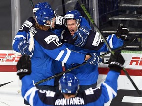 Finland's Antti Kalapudas (21) celebrates his goal against Canada with teammates Joni Tuulola (6) and Roope Hintz (10) during second period quarter-final hockey action at the IIHF World Junior Championship, in Helsinki, Finland, on Saturday, Jan. 2, 2016. THE CANADIAN PRESS/Sean Kilpatrick