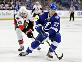 Tampa Bay Lightning left wing Jonathan Drouin (27) loses the puck to a stick-check by Ottawa Senators center Mika Zibanejad (93), of Sweden, during the first period of an NHL hockey game Thursday, Dec. 10, 2015, in Tampa, Fla. (AP Photo/Chris O'Meara)