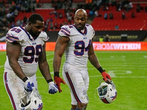 Buffalo Bills defensive tackle Marcell Dareus (99) and defensive end Mario Williams (94)  leave the field after the NFL game between Buffalo Bills and Jacksonville Jaguars at Wembley Stadium in London,  Sunday, Oct. 25, 2015. The Jaguars won 34-31. (AP Photo/Matt Dunham)