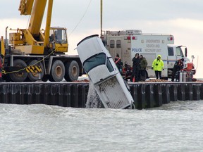 A crane lifts a pickup truck from Lake Huron shortly after 4 p.m. Saturday. The vehicle had driven off Kincardine Harbour?s north pier The body of an unidentified man was found inside. Darryl Coote/Kincardine News