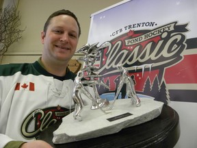 ERNST KUGLIN/The Intelligencer
Capt. Jeff Moorehouse, of 436 Squadron, holds the winning trophy for the CFB Trenton Pond Hockey Classic that starts Friday, Jan. 29 with the Puck Drop Dinner held at the Batawa Community Centre. The four-on-four tournament will be played on four outdoor rinks in Batawa on Jan. 30 and 31. The fund raising goal for 2016 is $50,000. Proceeds will be split between Wounded Warriors Canada and Trenton Memorial Hospital Foundation.