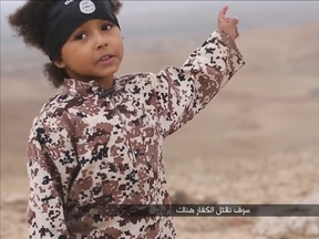A child speaks in this still image from a handout video obtained on January 4, 2016 from a social media website which has not been independently verified. Britain was on Monday examining the Islamic State video showing a young boy in military fatigues and an older masked militant who both spoke with British accents. The propaganda video, which could not be independently verified, also shows the killing of five men accused of spying for the West. (REUTERS/Social Media via Reuters TVA)