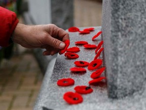 A man places a poppy on the cenotaph following the conclusion of the Remembrance Day ceremony Wednesday November 11, 2015 in Belleville, Ont. 

Emily Mountney-Lessard/Belleville Intelligencer/Postmedia Network