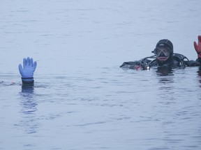 Mike Hill, left, and Gaetan Grondin dive near the Murney Towner in Lake Ontario near Kingston General Hospital recently. (Jolson Lim/For The Whig-Standard)