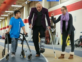 Alexander Morrison, 9, (L) and Megan Sherwin, 15, help Mike Strobel kick off the Variety Village Christmas Fund on November 13, 2015. The annual campaign raised more than $30,000. (Veronica Henri/Toronto Sun)