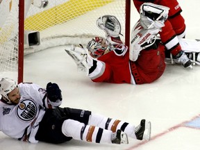 Edmonton Oilers Fernando Pisani (L) celebrates after scoring a goal against the Carolina Hurricanes as Hurricanes goalie Cam Ward lies in the net during the third period of Game 7 of their NHL Stanley Cup Finals ice hockey game in Raleigh, North Carolina, June 19, 2006.