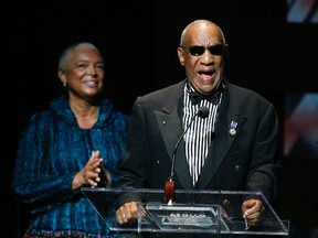Comedian Bill Cosby addresses the crowd in front of his wife, Camille Cosby, after being honored during the Apollo Theatre's 75th anniversary gala in New York, in this June 8, 2009 file photo.  REUTERS/Lucas Jackson/Files