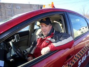 Kingston taxi driver and broker Kevin Murphy with his Amey's taxi in Kingston on Monday. (Ian MacAlpine/The Whig-Standard)