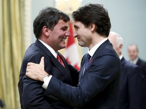 Canada's new Leader of the Government in the House of Commons Dominic LeBlanc (L) is congratulated by Prime Minister Justin Trudeau at Rideau Hall in Ottawa on November 4, 2015. Trudeau and LeBlanc have rejected mounting calls for a referendum on any future changes to the electoral process. REUTERS/Chris Wattie