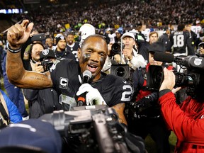 Raiders’ Charles Woodson addresses the crowd after he retired following a loss to the Chargers on Sunday. (AP)