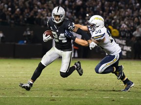 Raiders free safety Charles Woodson (24) carries the ball against Chargers inside linebacker Manti Te'o (50) during overtime at O.co Coliseum in Oakland, Calif., on Dec. 24, 2015. The Raiders, Chargers and Rams all submitted formal applications for relocation to Los Angeles on Monday, Jan. 4, 2016. (Kelley L Cox/USA TODAY Sports)