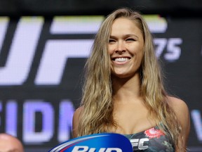In this July 4, 2014, file photo, Ronda Rousey stands on the scale during a weigh-in for UFC 175 at the Mandalay Bay in Las Vegas. (AP Photo/John Locher, File)