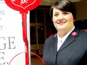 Capt. Nancy Braye stands by one of the Salvation Army’s iconic red kettles in mid-November at the start of the annual campaign. On Tuesday, the Salvation Army said it had raised more than $126,000 to meet the organization’s food bank and community program commitments. (Sarnia Observer file photo)