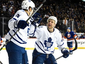 Toronto Maple Leafs left wing James van Riemsdyk (21) celebrates his empty net goal with Toronto Maple Leafs centre Leo Komarov (47) during the third period of an NHL hockey game against the New York Islanders on Sunday, Dec. 27, 2015, in New York. The Maple Leafs won 3-1. (AP Photo/Kathy Kmonicek)