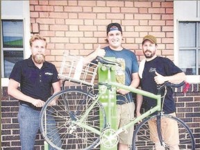 Steam Whistle?s Adrian, centre, and Andrew, left, introduce an avid cyclist to one of the craft brewer?s bicycle repair stations installed along numerous bike trails.