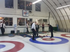 Last rock thrown at old City View Curling Club by founding member Carmine Luciani and swept by Conrad Uniacke and Paul Hennessey. (Submitted)