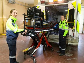 Hayley Jackson and Damien Gons of Middlesex-London EMS display one of their new powered stretchers that can lift up to 700 lbs. (MIKE HENSEN, The London Free Press)