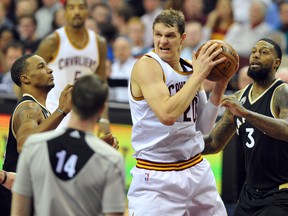 Timofey Mozgov (left) and the Cavaliers ran circles around James Johnson and the Raptors on Monday night. (USA TODAY)