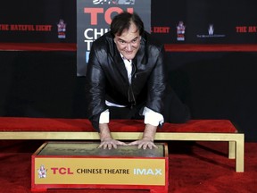 Director Quentin Tarantino places his handprints in cement in the forecourt of the TCL Chinese Theatre in Hollywood, California on January 5, 2016. REUTERS/Mario Anzuoni