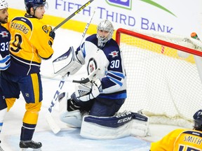 Jan 5, 2016; Nashville, TN, USA; Winnipeg Jets goalie Connor Hellebuyck (30) makes a save against the Nashville Predators during the third period at Bridgestone Arena. Mandatory Credit: Christopher Hanewinckel-USA TODAY Sports