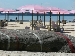 Waterfront Toronto spent more than $500,000 on two painted rocks and $11,565 on 36 pink umbrellas at Sugar Beach. (Dave Abel/Toronto Sun)