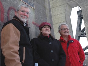 In celebration of the 86th anniversary of the opening of the Michigan Central Railroad bridge - it opened Jan. 3, 1930 - the structure was the scene of a heritage plaque ceremony Tuesday morning. Pictured from left - Serge Lavoie, president of On Track St. Thomas; Mayor Heather Jackson; Frank Lattanzio, chairman of the city's Municipal Heritage Committee. A small circular plaque was affixed to one of the pillars, immediately below the civil engineering plaque already in place. A bridge has been on this site since 1871, making the railway right of way just four years younger than Canada.