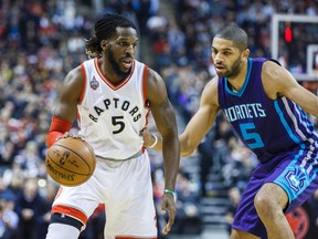 Toronto Raptors DeMarre Carroll and Charlotte Hornets Nicolas Batum during first half action in Toronto on January 1, 2016. (Ernest Doroszuk/Toronto Sun)