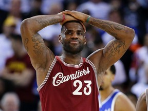 Cleveland Cavaliers’ LeBron James holds his hands over his head in a loss to the Golden State Warriors Friday, Dec. 25, 2015, in Oakland, Calif. (AP Photo/Marcio Jose Sanchez)