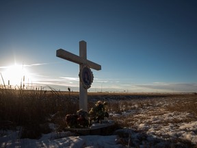 A memorial to a previous crash marks the intersection at Wanuskewin Rd and Highway 11, outside of Saskatoon, Saskatchewan. The intersection was the scene of tragedy where a family of four were killed in a collision with an SUV Sunday morning.  THE CANADIAN PRESS/Matthew Smith