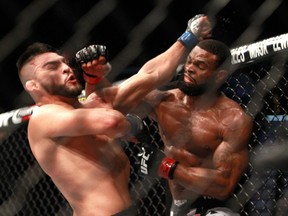 Tyron Woodley (R) connects with a punch on Kelvin Gastelum in their welterweight bout during UFC 183 at the MGM Grand Garden Arena in Las Vegas on Jan. 31, 2015. (Steve Marcus/Getty Images/AFP)