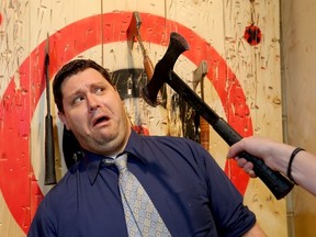 Sun scribe Shawn Logan has some fun with Tiffanee Ford, General Manager for AXE Throwing Calgary who have recently opened up shop in Calgary on Wednesday January 6, 2016. Darren Makowichuk/Calgary Sun/Postmedia Network