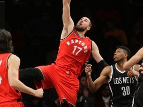 Raptors' Jonas Valanciunas (17) dunks the ball as Nets' Thaddeus Young (30) watches during second half NBA action in New York City on Wednesday, Jan. 6, 2016. (Frank Franklin II/AP Photo)