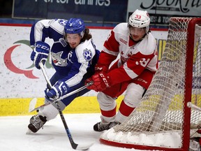 Sudbury Wolves captain Danny Desrochers takes the puck around the Soo Greyhounds goal with Greyhounds' Gabe Guertler in hot pursuit during OHL action at Sudbury Community Arena on Wednesday night.