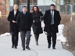 Const. James Forcillo, second from left, arrives at court for closing arguments in his trial for the shooting death of Sammy Yatim, on Jan. 5, 2016. (THE CANADIAN PRESS/Nathan Denette)