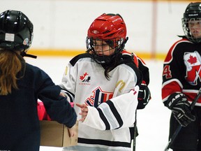 Wallaceburg Atom girls hockey player Jerzee Blackbird hands out gift bags to Mooretown players, following a game played on Saturday at Wallaceburg Memorial Arena. Wallaceburg shut out Mooretown 2-0. The game was part of the first-ever Girls Hockey Day, which featured all three Wallaceburg girls hockey teams in action. It was also a fundraiser for Cystic Fibrosis Canada.