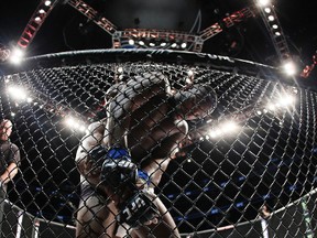 Kamaru Usman is pinned to the cage by Leon Edwards during UFC Fight Night at Amway Center in Orlando on Dec. 19, 2015. (Reinhold Matay-USA TODAY Sports)