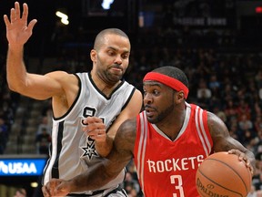 Houston Rockets guard Ty Lawson, right, drives around San Antonio Spurs guard Tony Parker during the first half of an NBA basketball game in San Antonio Jan. 2, 2016. (AP Photo/Darren Abate)