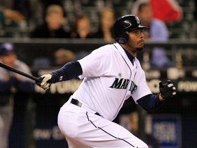 In this May 6, 2010, file photo, Seattle Mariners outfielder Ken Griffey Jr. hits against the Tampa Bay Rays in Seattle. (AP Photo/Elaine Thompson, File)