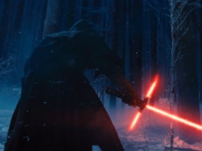 This photo provided by Disney shows, Adam Driver as Kylo Ren with his Lightsaber in a scene from the new film, "Star Wars: The Force Awakens." (Film Frame/Disney/Copyright Lucasfilm 2015 via AP)