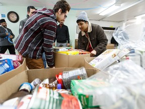 Volunteers with Ahmadiyya Muslim Youth Association pack an Edmonton's Food Bank truck full of food donations at Hadi Mosque in Edmonton, Alta., on Thursday January 7, 2016. Over 8,000 pounds were donated as part of the cross Canada Million Pounds Food Drive. Ian Kucerak/Edmonton Sun/Postmedia Network