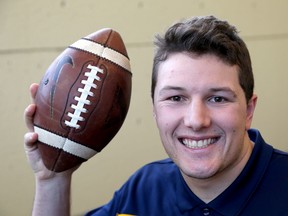 Allen Champagne, a master's student at Queen's University and defensive lineman for the Queen's Golden Gaels, is doing concussion research. (Ian MacAlpine/The Whig-Standard)