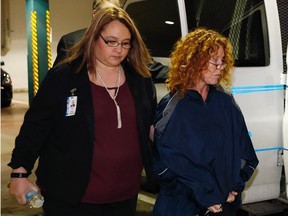 Tonya Couch (R) is escorted by a sheriff's deputy as she arrives at the Tarrant County Jail in Fort Worth, Texas, January 7, 2016.  Couch, the mother of Texas teenager Ethan Couch, derided for a defense of "affluenza" in his trail for killing four people while driving drunk, was flown on Thursday from Los Angeles to Texas, where she faces an indictment for helping her son escape to Mexico.  REUTERS/Paul Moseley/Ft. Worth Star-Telegram/Pool
