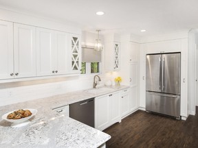A crisp white kitchen with Cambria quartz Summerhill countertops, vinyl plank flooring and stainless appliances. (Designer: Cassandra Nordell/Copyright William Standen Co. 2015)