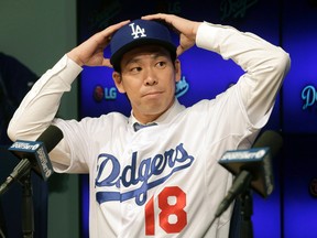 Newly signed Los Angeles Dodgers pitcher Kenta Maeda is introduced at a news conference in Los Angeles Thursday, Jan. 7, 2016. (AP Photo/Nick Ut)